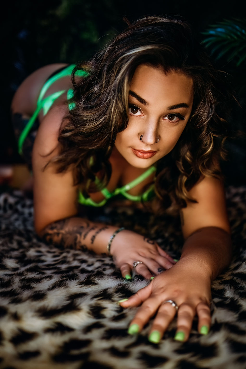 A woman in neon green lingerie crawls across a leopard print rug microblading annapolis